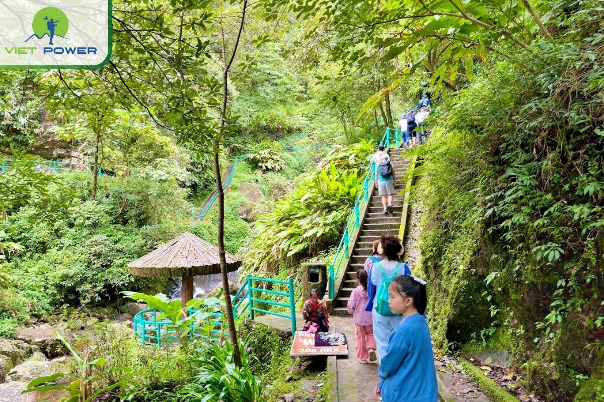 Climb two stone steps that run along the waterfall