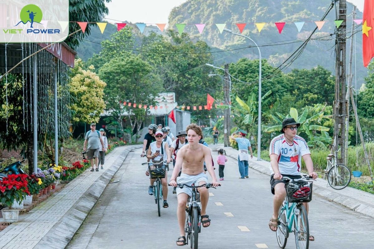 Cycling through village pathways at Viet Hai Village (Cat Ba Island). 